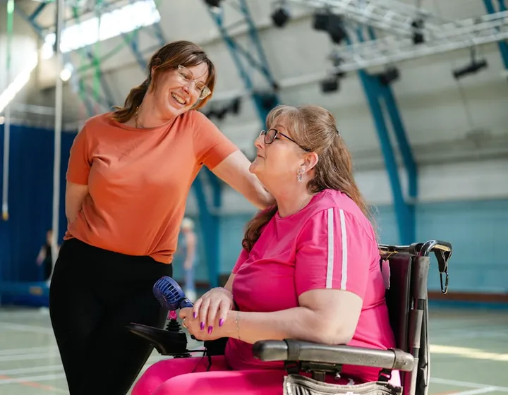 A support worker and a participant getting through the morning routine at home