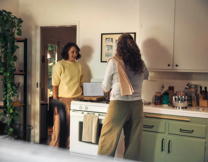 A participant cooking at home with a support worker alongside